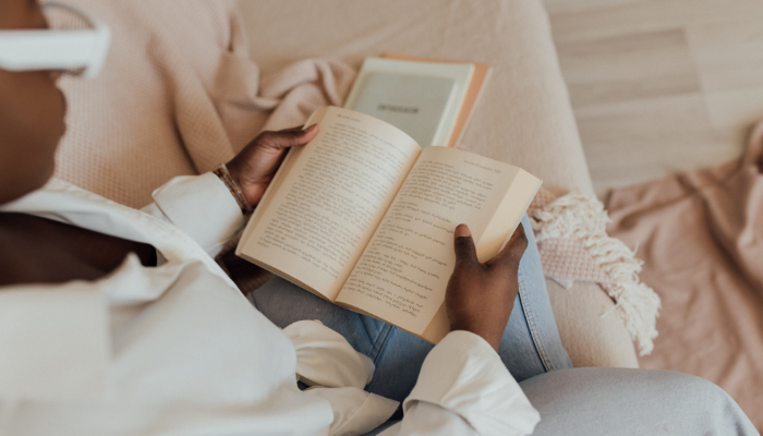 Someone sitting down reading a book